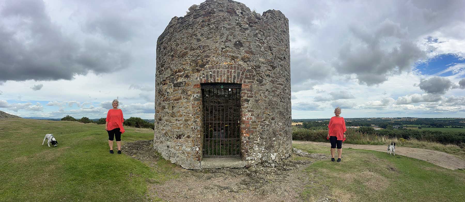 Tina O Rourke - Irish Writer Tina O'Rourke beside a stone tower in the Irish countryside